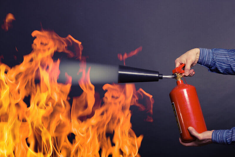 Man Using Fire Extinguisher